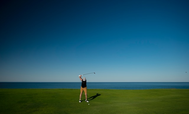 man-playing-golf-along-the-seaside