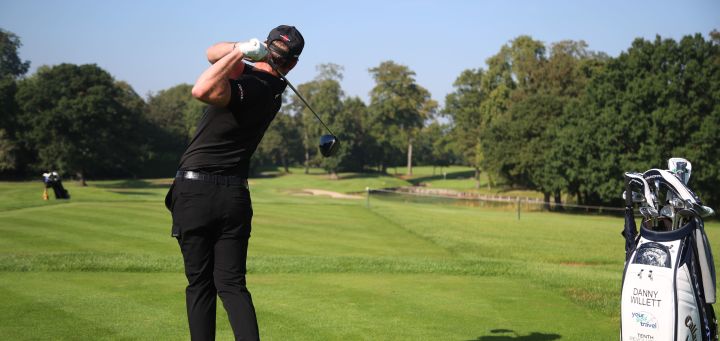 man-beside-golf-bag-swinging