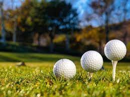 three-golf-balls-on-course